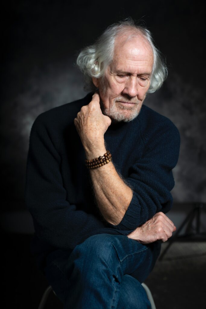 An older man sits